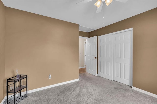 unfurnished bedroom featuring light carpet, a closet, and ceiling fan