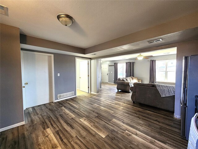 interior space with dark hardwood / wood-style floors, ceiling fan, and a textured ceiling