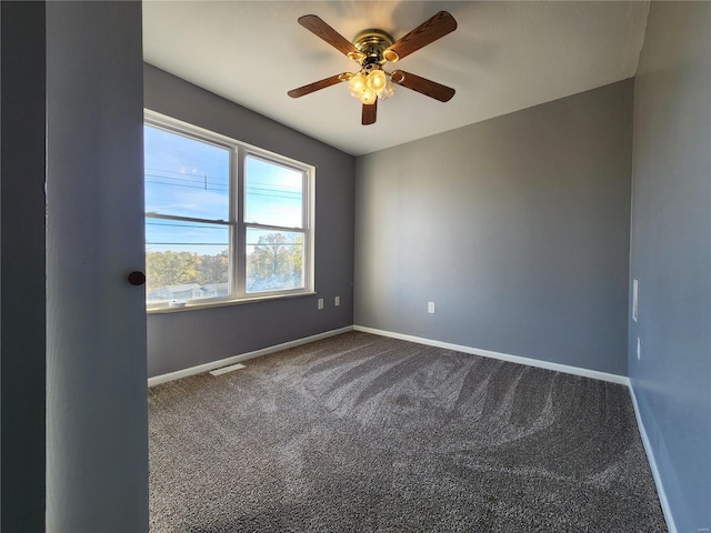 spare room featuring carpet flooring and ceiling fan