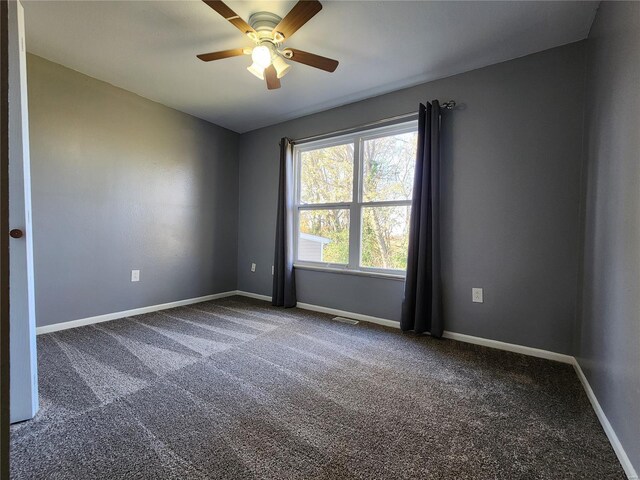 spare room featuring carpet flooring and ceiling fan