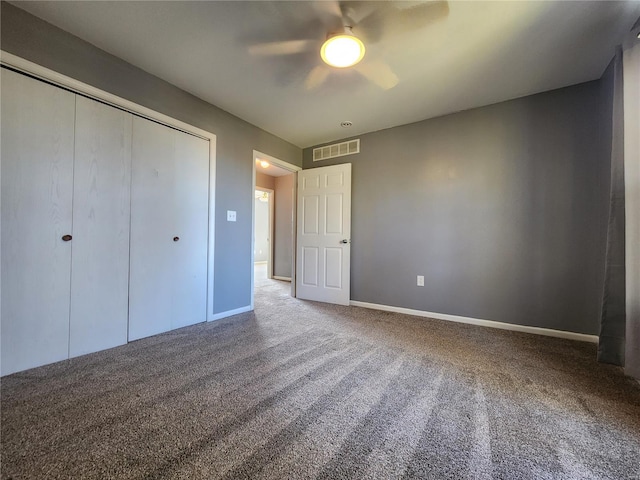 unfurnished bedroom with carpet flooring, ceiling fan, and a closet