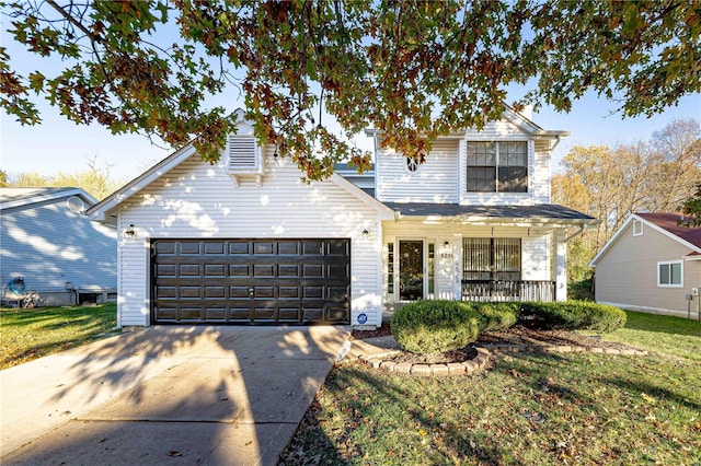 view of property featuring a front lawn, covered porch, and a garage