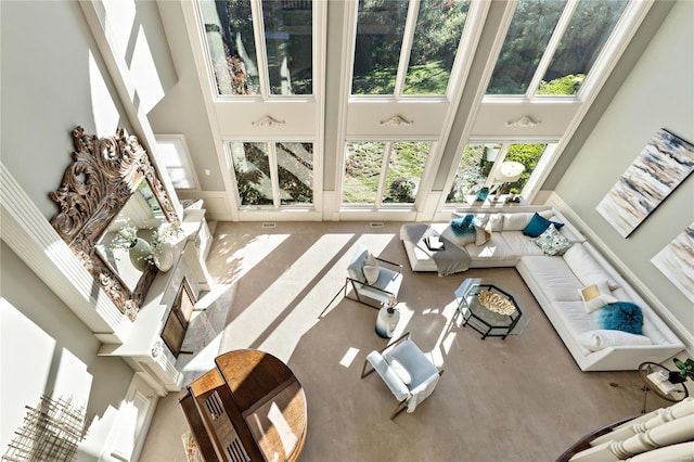 living room with carpet and a towering ceiling