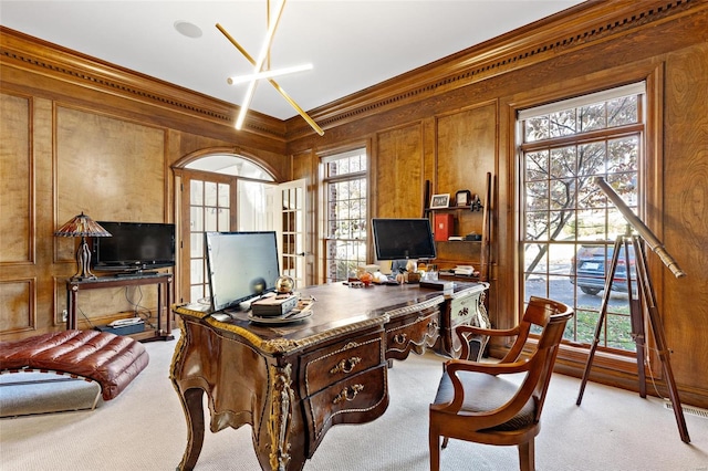 office area with light carpet, crown molding, and wood walls