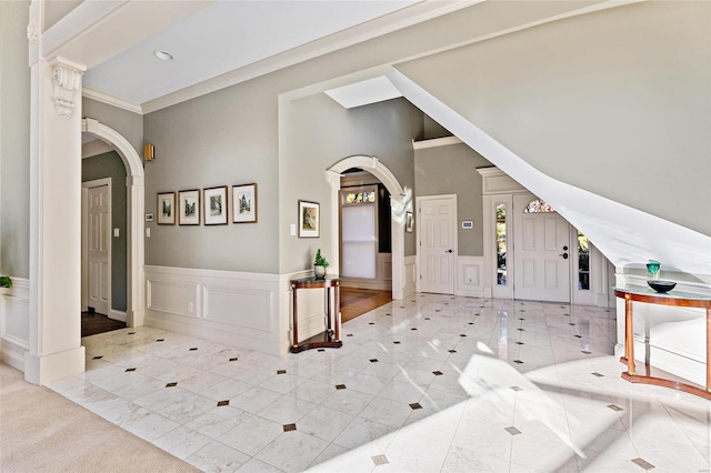 entryway featuring crown molding and light tile patterned floors