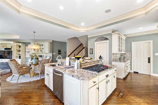 kitchen featuring light stone countertops, appliances with stainless steel finishes, dark hardwood / wood-style floors, and hanging light fixtures