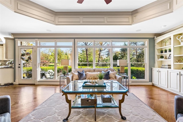 sunroom / solarium featuring plenty of natural light and ceiling fan