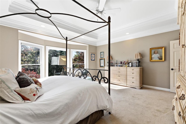 bedroom featuring a raised ceiling, ceiling fan, light colored carpet, and ornamental molding