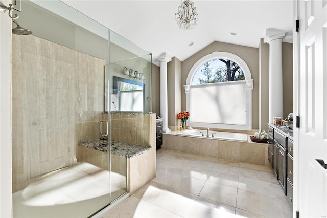 bathroom featuring decorative columns, separate shower and tub, vanity, and vaulted ceiling