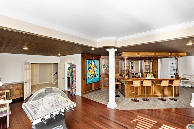 bar featuring crown molding and hardwood / wood-style floors