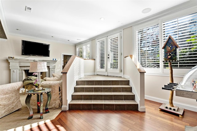 stairway featuring hardwood / wood-style flooring and ornamental molding