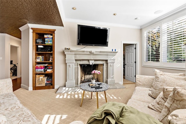 living room featuring light colored carpet, ornamental molding, and a tile fireplace