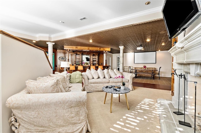 living room featuring crown molding, light carpet, and decorative columns