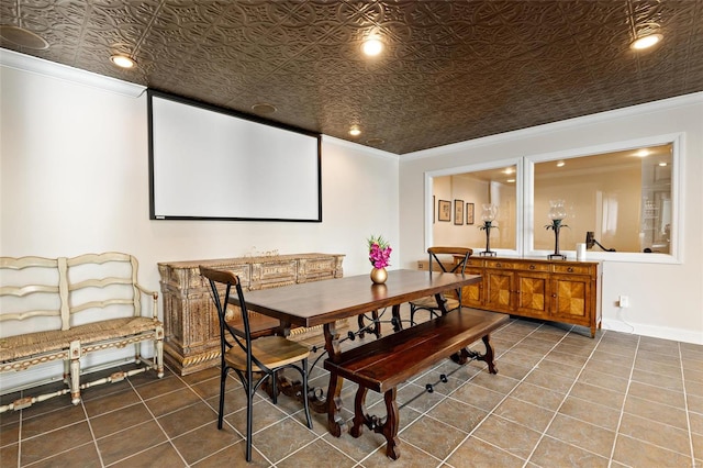 home theater room with tile patterned floors and crown molding