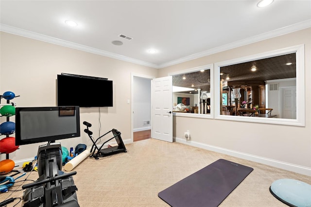 exercise area featuring carpet flooring and crown molding