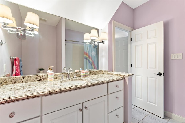 bathroom featuring tile patterned flooring, vanity, and walk in shower