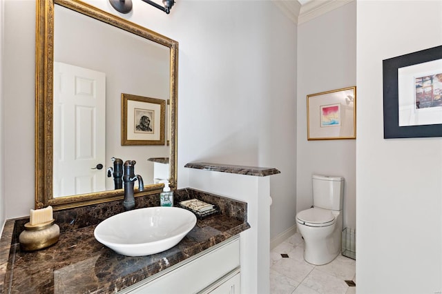 bathroom featuring vanity, toilet, and crown molding