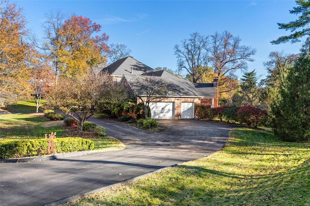 view of side of property featuring a lawn and a garage