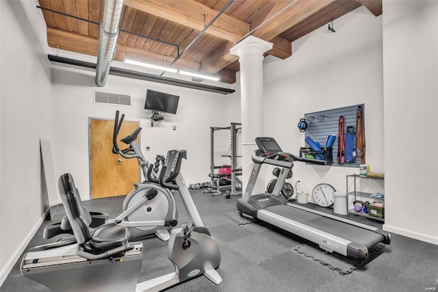 workout area featuring ornate columns and wooden ceiling