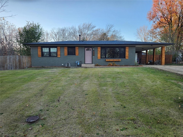 ranch-style home with a carport and a front lawn