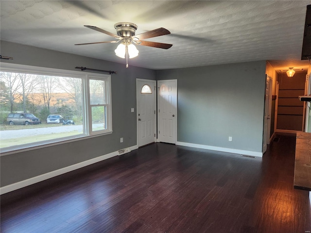 interior space with dark hardwood / wood-style floors, ceiling fan, and a textured ceiling