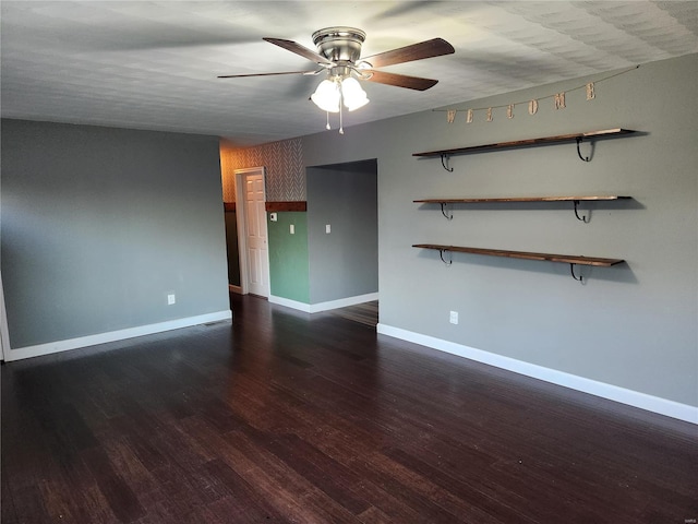 spare room with dark hardwood / wood-style floors and ceiling fan