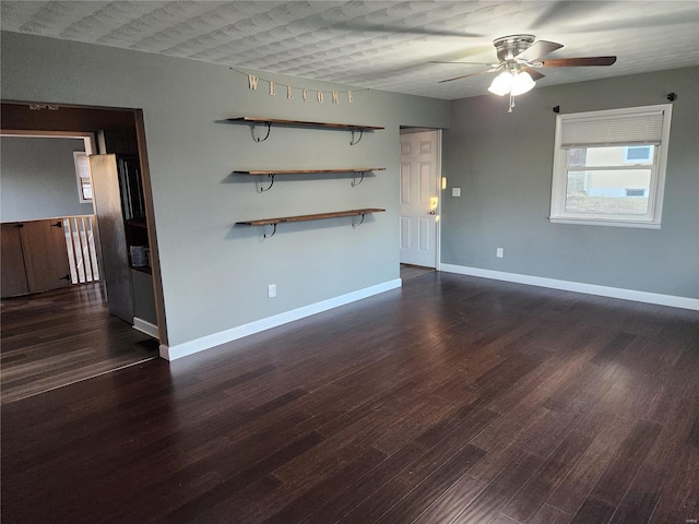 empty room featuring dark hardwood / wood-style floors and ceiling fan