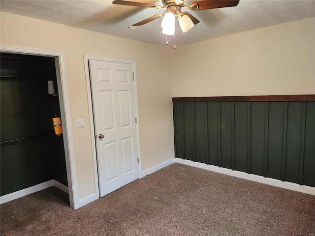 unfurnished bedroom featuring ceiling fan and carpet