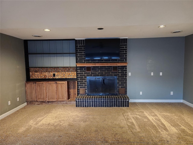 unfurnished living room featuring carpet flooring and a fireplace