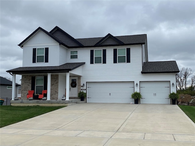 view of front of property with covered porch and a garage