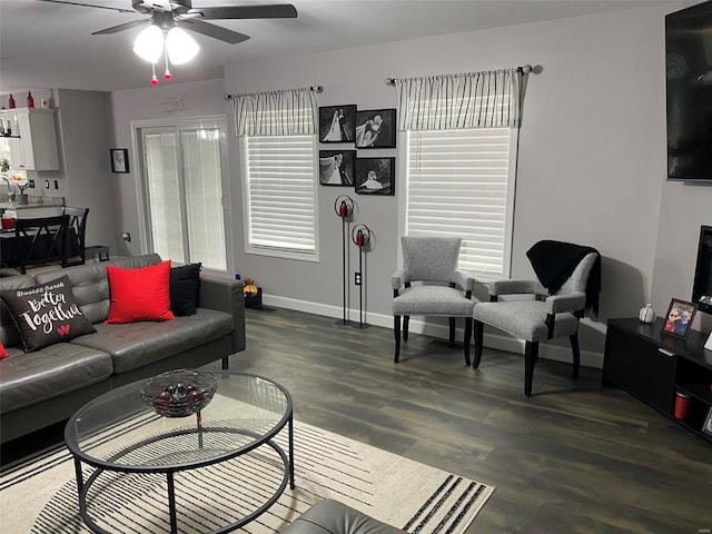 living room featuring plenty of natural light, ceiling fan, and dark hardwood / wood-style flooring