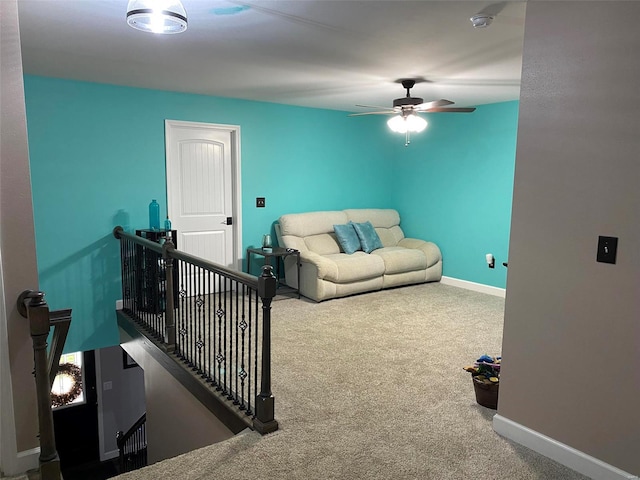 carpeted living room with ceiling fan