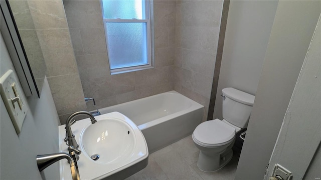 bathroom with tile patterned floors, tiled shower / bath combo, and toilet