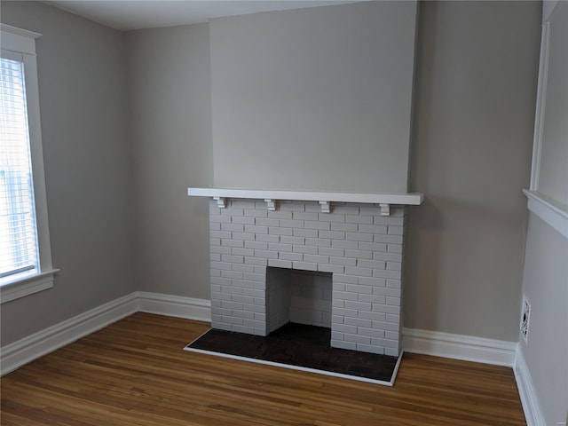 room details featuring hardwood / wood-style flooring and a brick fireplace