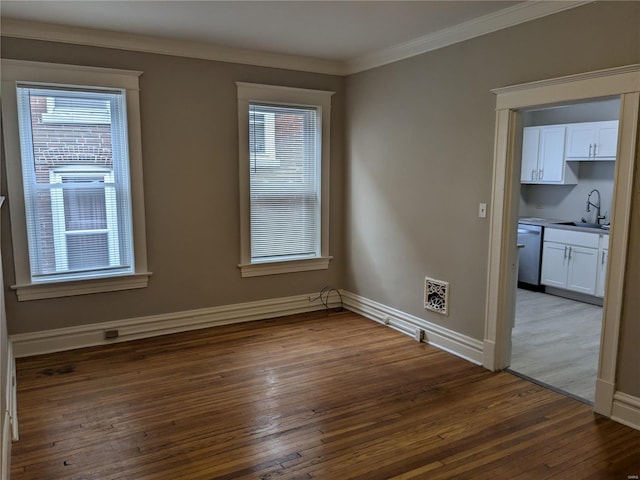 empty room with dark hardwood / wood-style flooring, ornamental molding, and sink