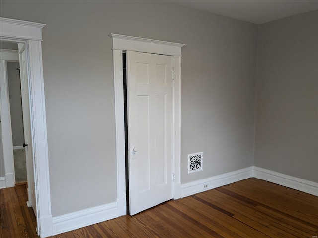 unfurnished bedroom with dark wood-type flooring