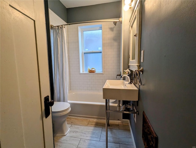 full bathroom with toilet, sink, and shower / tub combo with curtain