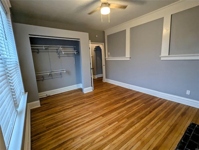 unfurnished bedroom featuring a closet, ceiling fan, and hardwood / wood-style flooring