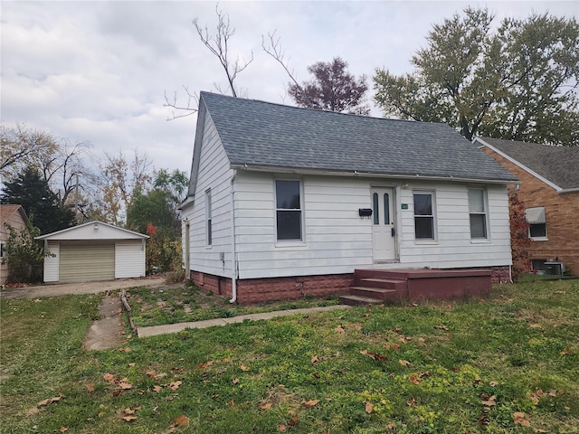 bungalow with a front lawn, central AC unit, an outdoor structure, and a garage