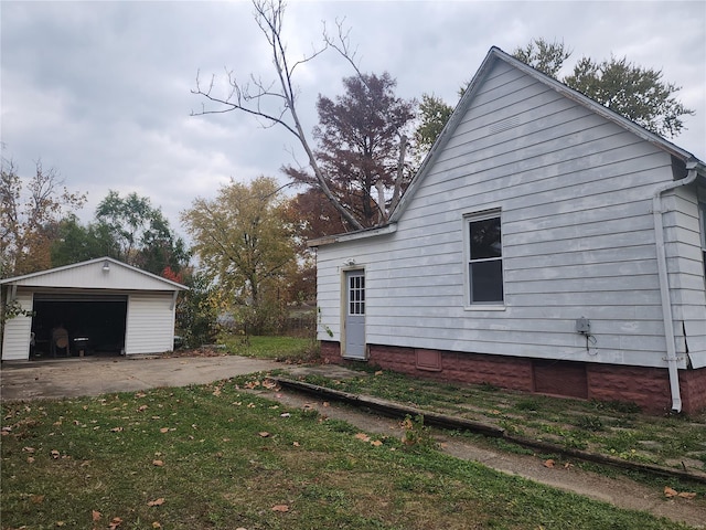 view of side of property with a yard, an outbuilding, and a garage