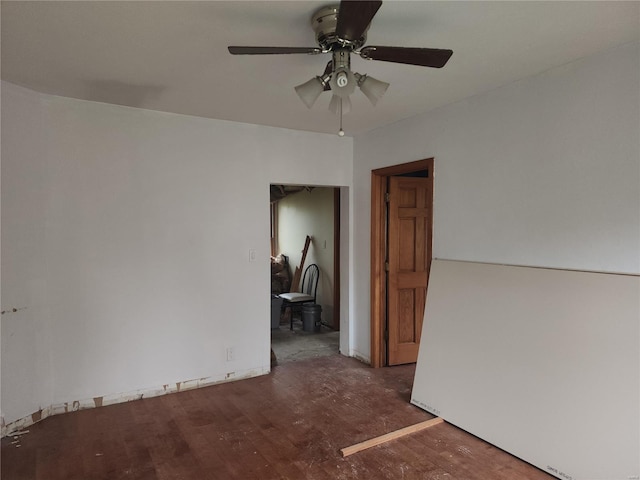 unfurnished room featuring ceiling fan and dark wood-type flooring