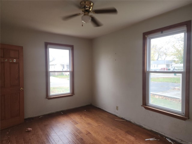 spare room with hardwood / wood-style floors and ceiling fan