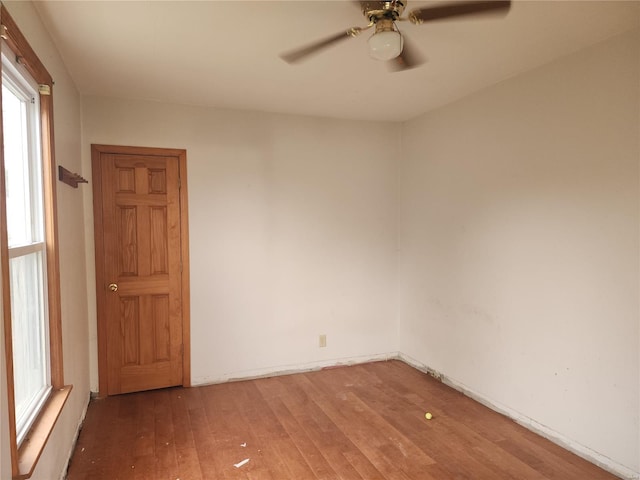 spare room with ceiling fan and wood-type flooring