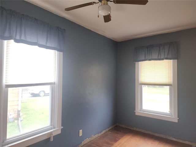 spare room with hardwood / wood-style floors, plenty of natural light, and ceiling fan