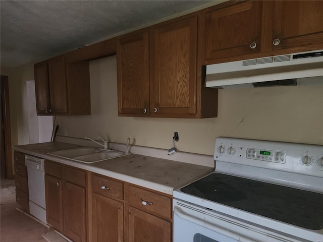 kitchen featuring a textured ceiling, sink, and white appliances