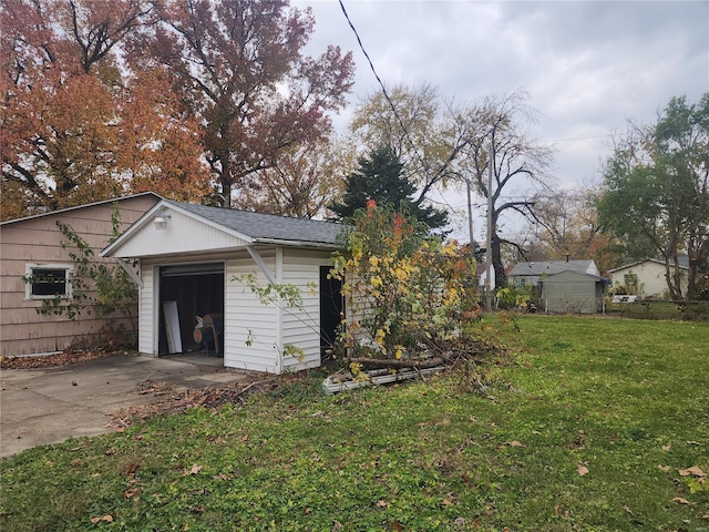 exterior space with an outbuilding, a garage, and a front yard