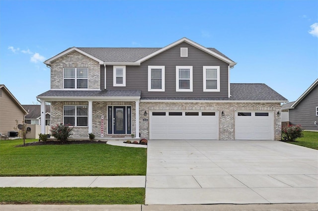 view of front property featuring a garage and a front lawn