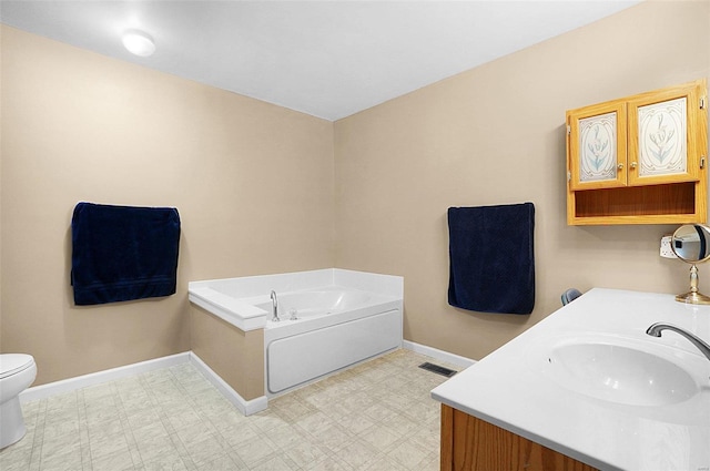 bathroom featuring a bath, vanity, and toilet