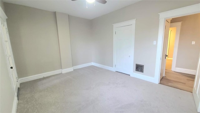 unfurnished bedroom featuring ceiling fan and light colored carpet