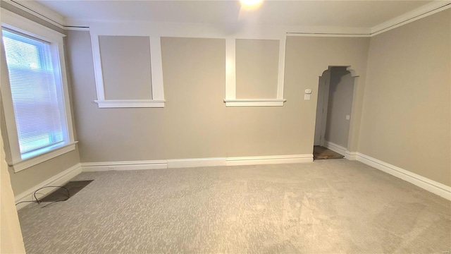 carpeted spare room featuring ornamental molding